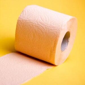 picture of a roll of toilet paper in front of a yellow background